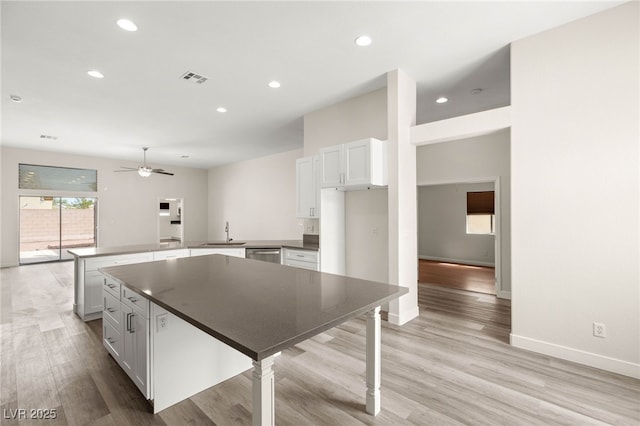 kitchen with recessed lighting, visible vents, stainless steel dishwasher, a sink, and a peninsula