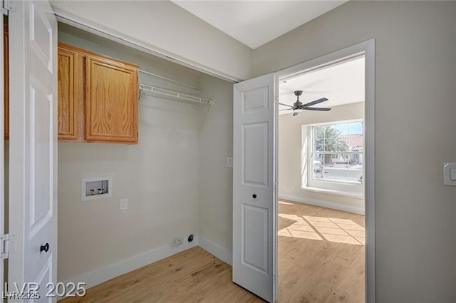 clothes washing area with hookup for a washing machine, ceiling fan, cabinet space, light wood finished floors, and baseboards