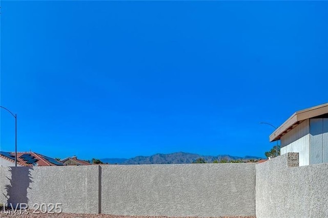 exterior details with a mountain view and fence