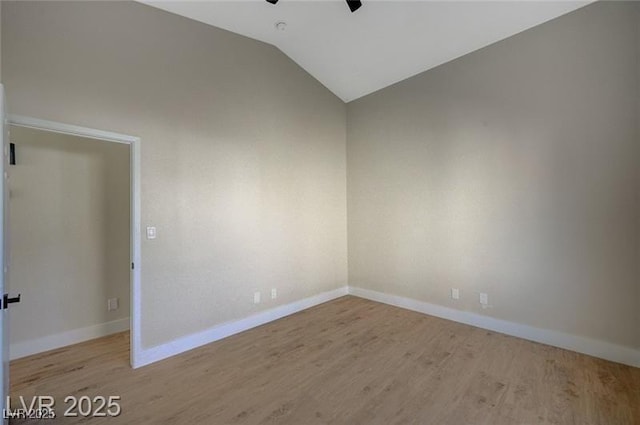 unfurnished room featuring lofted ceiling, a ceiling fan, wood finished floors, and baseboards