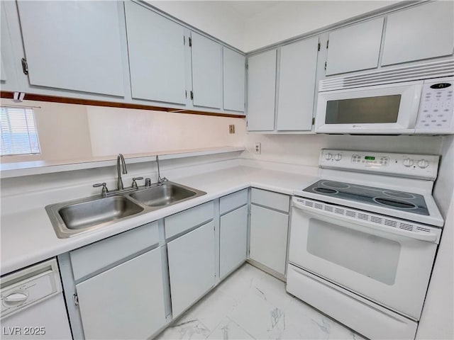 kitchen featuring light countertops, marble finish floor, a sink, and white appliances