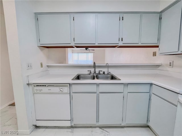 kitchen featuring a sink, dishwasher, marble finish floor, light countertops, and baseboards