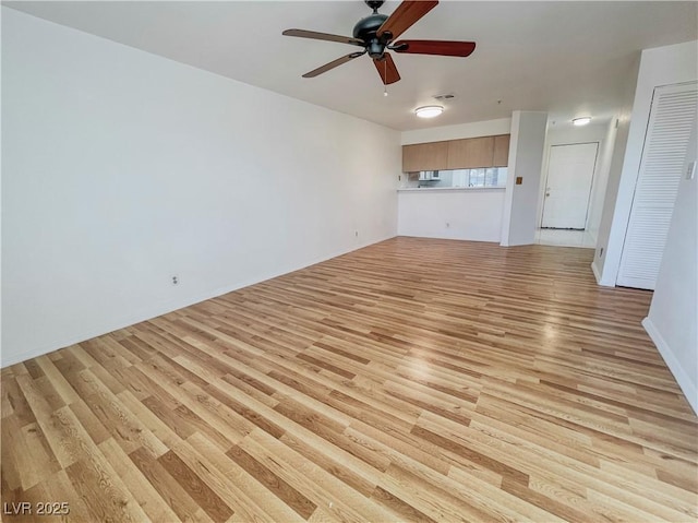 unfurnished living room with ceiling fan and light wood-style flooring