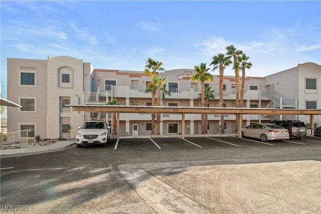 covered parking lot featuring a residential view