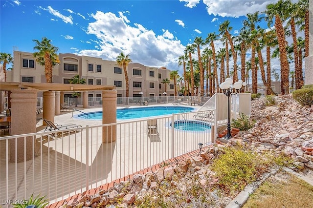community pool featuring a patio area and fence