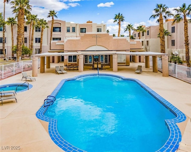 pool with a residential view, a patio area, and fence