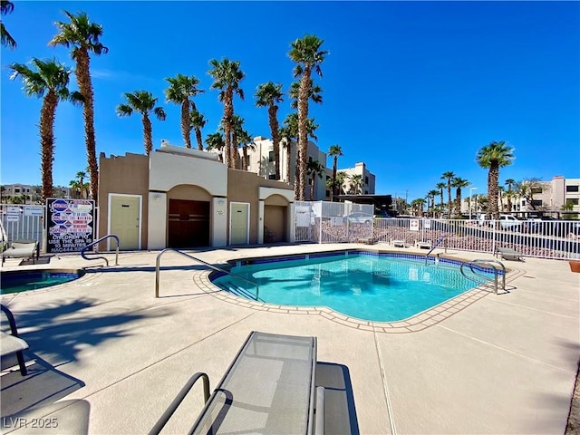 pool with fence and a patio area