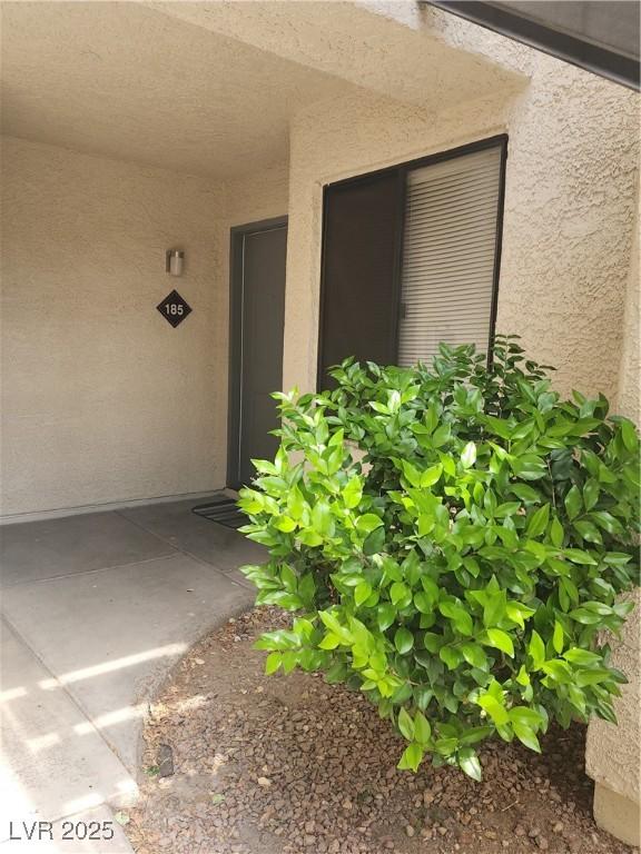 entrance to property with stucco siding