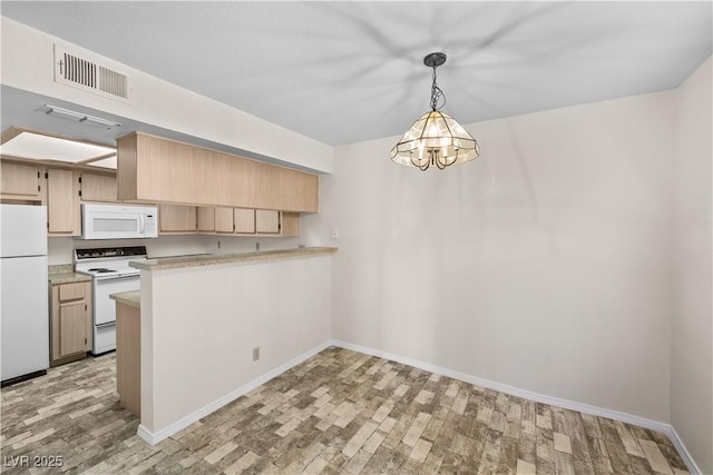 kitchen featuring light countertops, light wood-style floors, visible vents, and white appliances