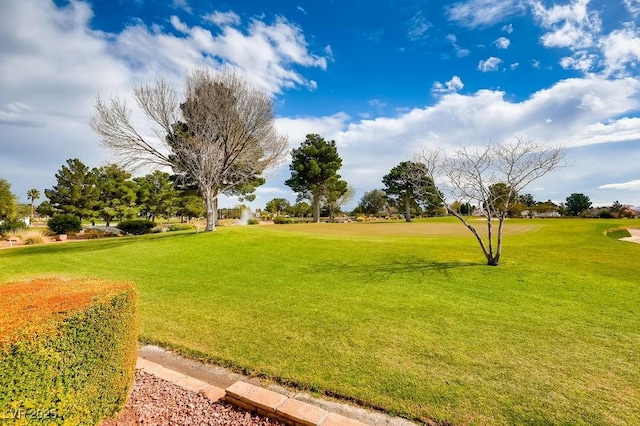 surrounding community with a yard and view of golf course