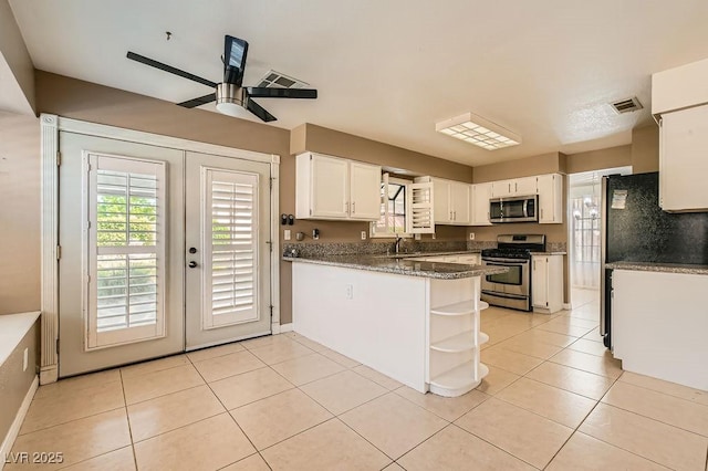 kitchen featuring open shelves, a sink, appliances with stainless steel finishes, white cabinetry, and visible vents