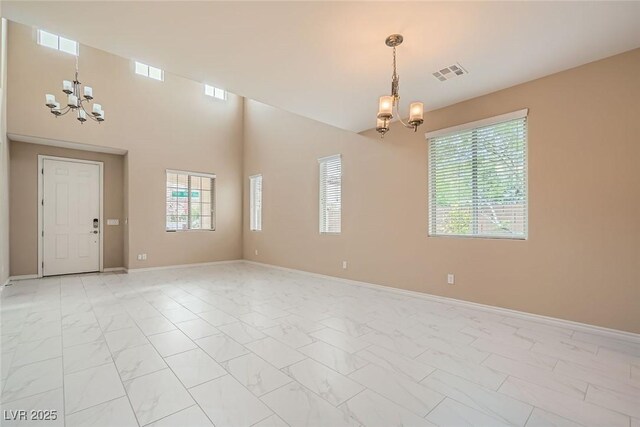 3428 Iron Hagen Ct, Las Vegas, NV 89141 - spare room featuring marble finish floor, an inviting chandelier, visible vents, and baseboards