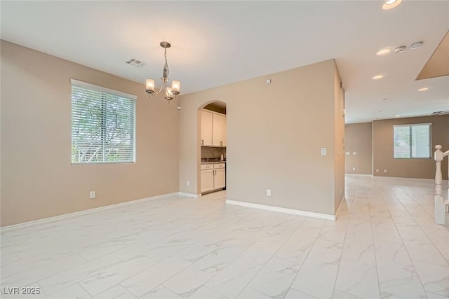 3428 Iron Hagen Ct, Las Vegas, NV 89141 - empty room with marble finish floor, arched walkways, and recessed lighting