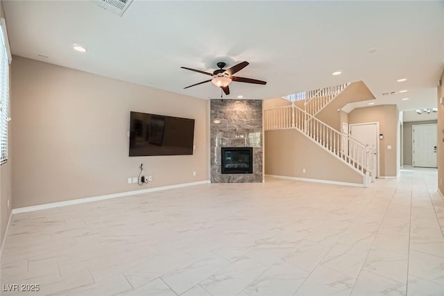3428 Iron Hagen Ct, Las Vegas, NV 89141 - unfurnished living room featuring baseboards, visible vents, a premium fireplace, a ceiling fan, and stairway