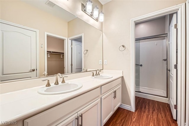 3428 Iron Hagen Ct, Las Vegas, NV 89141 - full bathroom with wood finished floors, a sink, double vanity, and a stall shower