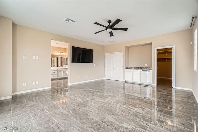 3428 Iron Hagen Ct, Las Vegas, NV 89141 - unfurnished living room featuring marble finish floor, visible vents, a ceiling fan, and baseboards
