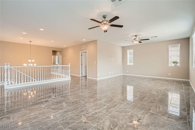 3428 Iron Hagen Ct, Las Vegas, NV 89141 - spare room featuring ceiling fan with notable chandelier, baseboards, visible vents, and marble finish floor