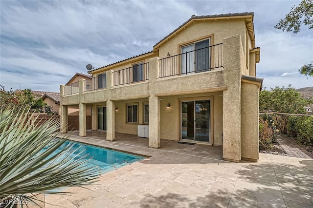 3428 Iron Hagen Ct, Las Vegas, NV 89141 - back of house featuring stucco siding, a patio area, a balcony, and a fenced backyard