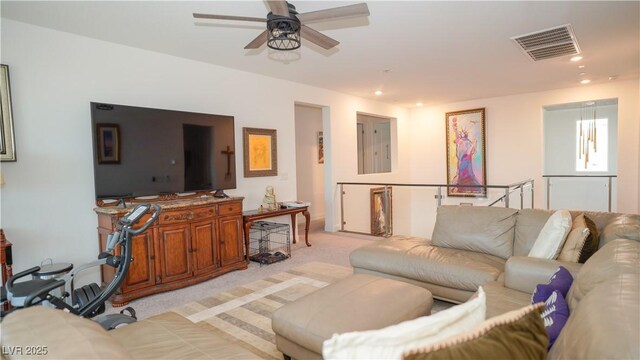 living room featuring recessed lighting, visible vents, a ceiling fan, and light colored carpet