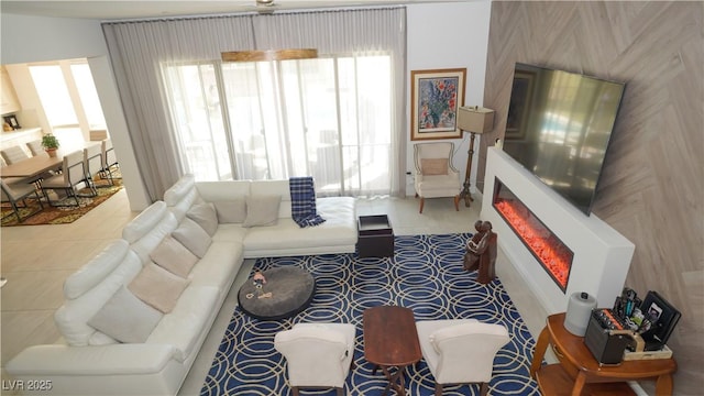 living room with a wealth of natural light and a glass covered fireplace