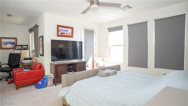 bedroom with visible vents, carpet flooring, and a ceiling fan