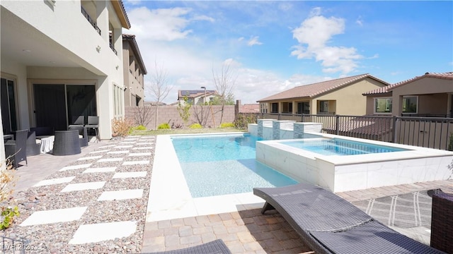 view of swimming pool featuring a patio, a fenced backyard, a fenced in pool, and an in ground hot tub