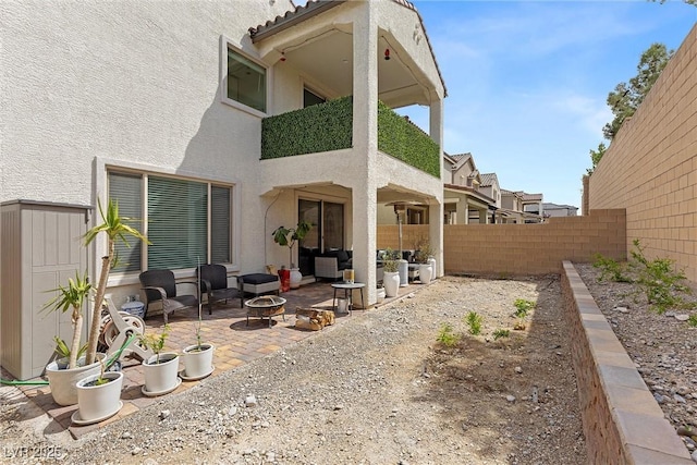 8107 Skye Sweep St, Las Vegas, NV 89166 - back of house with a patio, an outdoor fire pit, stucco siding, and a balcony