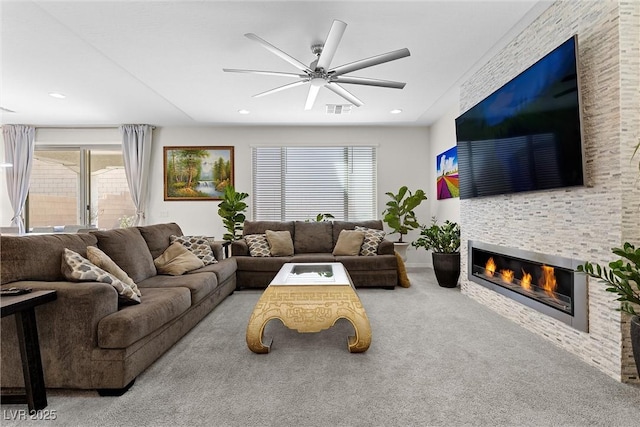 8107 Skye Sweep St, Las Vegas, NV 89166 - living area with visible vents, a healthy amount of sunlight, a tiled fireplace, and carpet floors