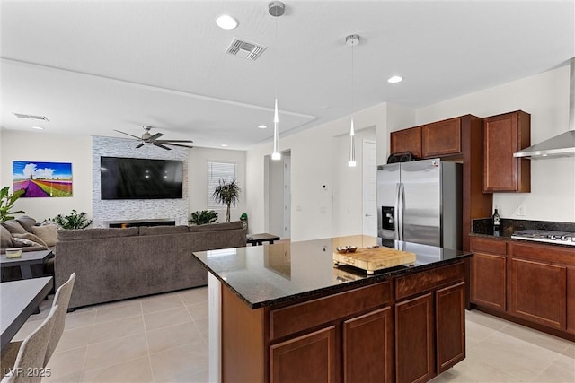 8107 Skye Sweep St, Las Vegas, NV 89166 - kitchen with stainless steel appliances, light tile patterned floors, visible vents, a ceiling fan, and wall chimney exhaust hood