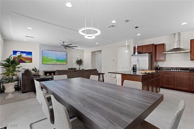 8107 Skye Sweep St, Las Vegas, NV 89166 - dining room featuring a warm lit fireplace, recessed lighting, ceiling fan, and visible vents