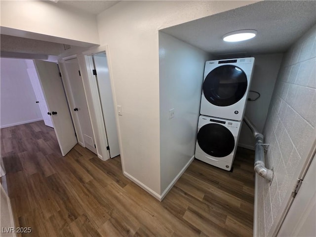 4754 Marnell Dr, Las Vegas, NV 89121 - washroom with stacked washer and dryer, baseboards, wood finished floors, and laundry area