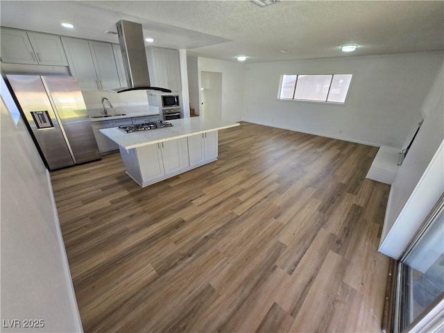4754 Marnell Dr, Las Vegas, NV 89121 - kitchen featuring a sink, wood finished floors, wall chimney range hood, light countertops, and appliances with stainless steel finishes