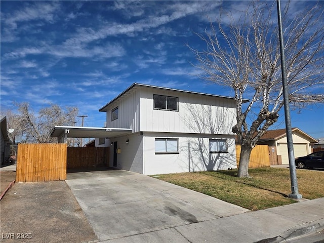 4754 Marnell Dr, Las Vegas, NV 89121 - view of front of property with concrete driveway, fence, an attached carport, and a front yard