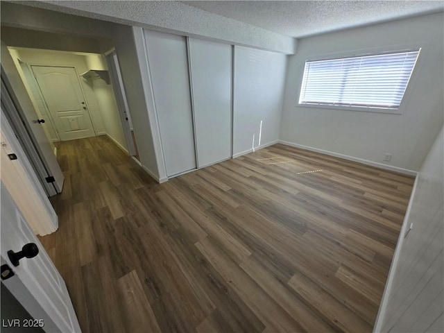 4754 Marnell Dr, Las Vegas, NV 89121 - unfurnished bedroom with baseboards, wood finished floors, a textured ceiling, and a closet