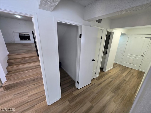 4754 Marnell Dr, Las Vegas, NV 89121 - hallway featuring visible vents, wood finished floors, and stairs