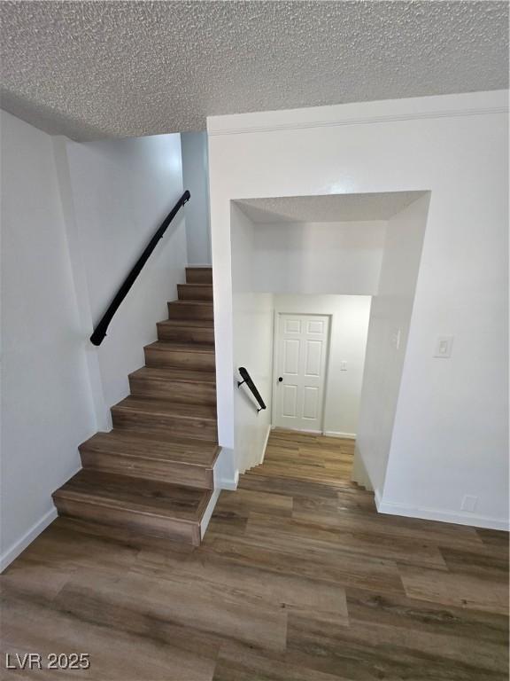 4754 Marnell Dr, Las Vegas, NV 89121 - stairs with wood finished floors, a textured ceiling, and baseboards