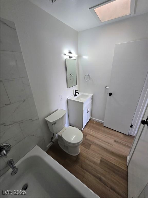 4754 Marnell Dr, Las Vegas, NV 89121 - bathroom with baseboards, wood finished floors, toilet, and vanity