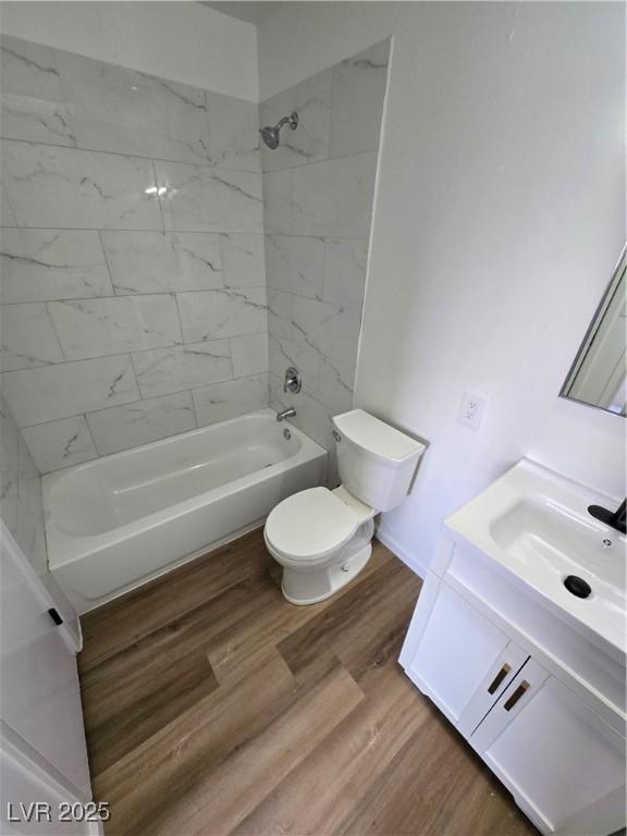 4754 Marnell Dr, Las Vegas, NV 89121 - bathroom with wood finished floors, toilet, vanity, and bathing tub / shower combination