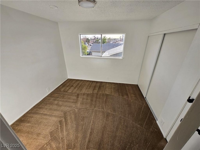 4754 Marnell Dr, Las Vegas, NV 89121 - unfurnished bedroom featuring a textured ceiling, carpet floors, and a closet