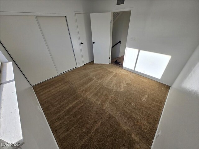 4754 Marnell Dr, Las Vegas, NV 89121 - unfurnished bedroom with carpet and two closets