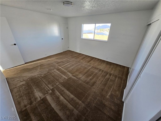 4754 Marnell Dr, Las Vegas, NV 89121 - unfurnished bedroom featuring carpet and a textured ceiling