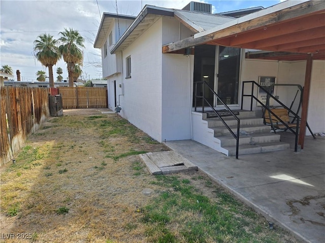 4754 Marnell Dr, Las Vegas, NV 89121 - view of side of home featuring fence, concrete block siding, and a patio