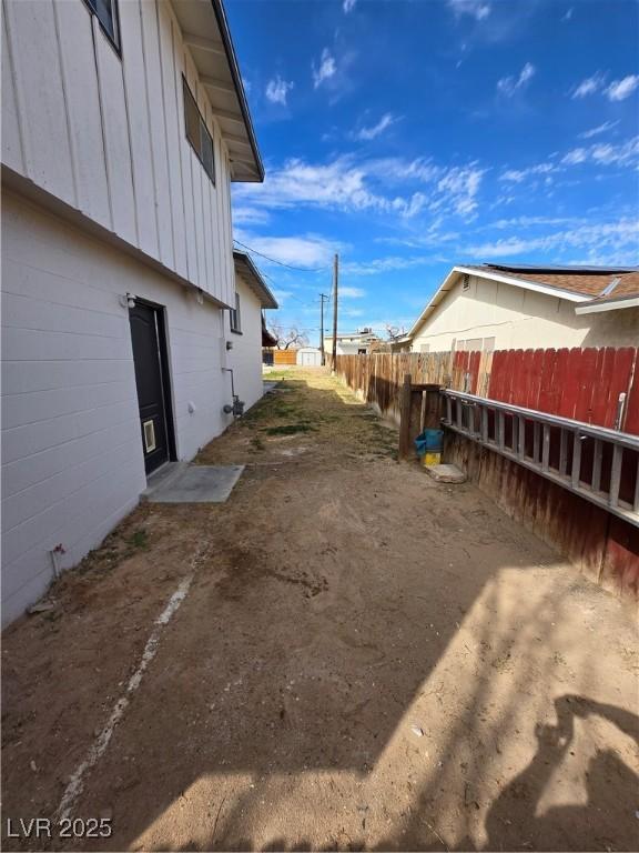 4754 Marnell Dr, Las Vegas, NV 89121 - view of side of home with a fenced backyard and board and batten siding