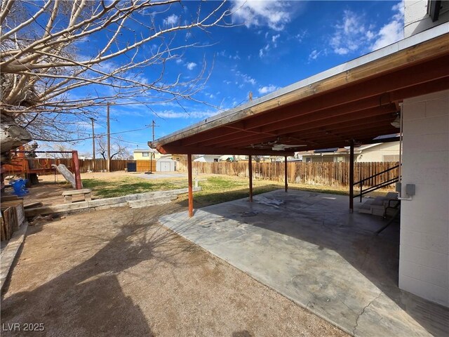 4754 Marnell Dr, Las Vegas, NV 89121 - view of patio / terrace with a fenced backyard, an outbuilding, and a storage unit