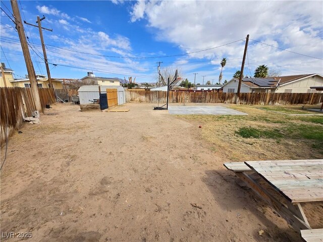 4754 Marnell Dr, Las Vegas, NV 89121 - view of yard with a storage shed, a patio, a fenced backyard, and an outdoor structure