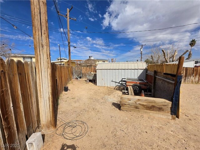 4754 Marnell Dr, Las Vegas, NV 89121 - view of yard with an outdoor structure, a shed, and a fenced backyard