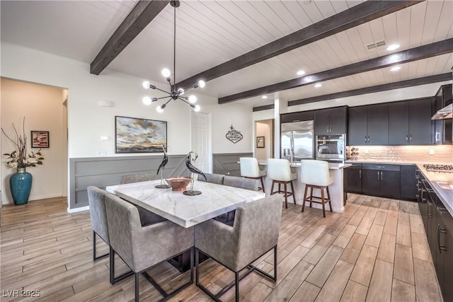 dining room with light wood-type flooring, visible vents, recessed lighting, a notable chandelier, and beamed ceiling
