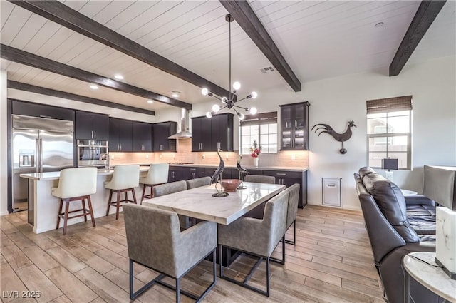 dining space featuring recessed lighting, visible vents, beamed ceiling, and light wood-style flooring