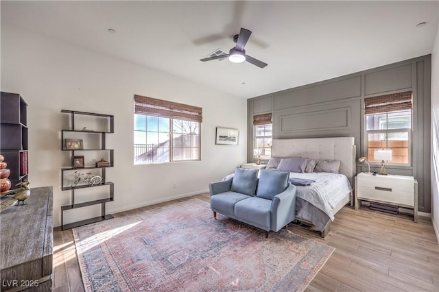bedroom featuring light wood-style flooring, baseboards, and a ceiling fan