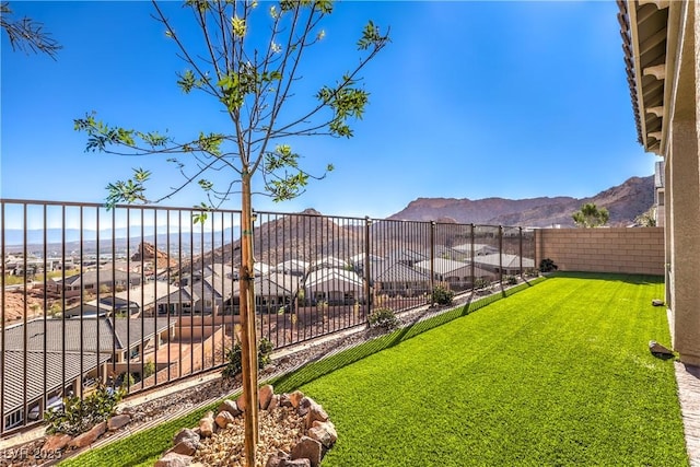 view of yard featuring a fenced backyard and a mountain view